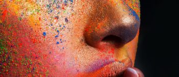Model with art make-up posing on dark background