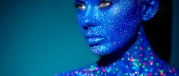 Portrait of beautiful woman with sparkles on her face